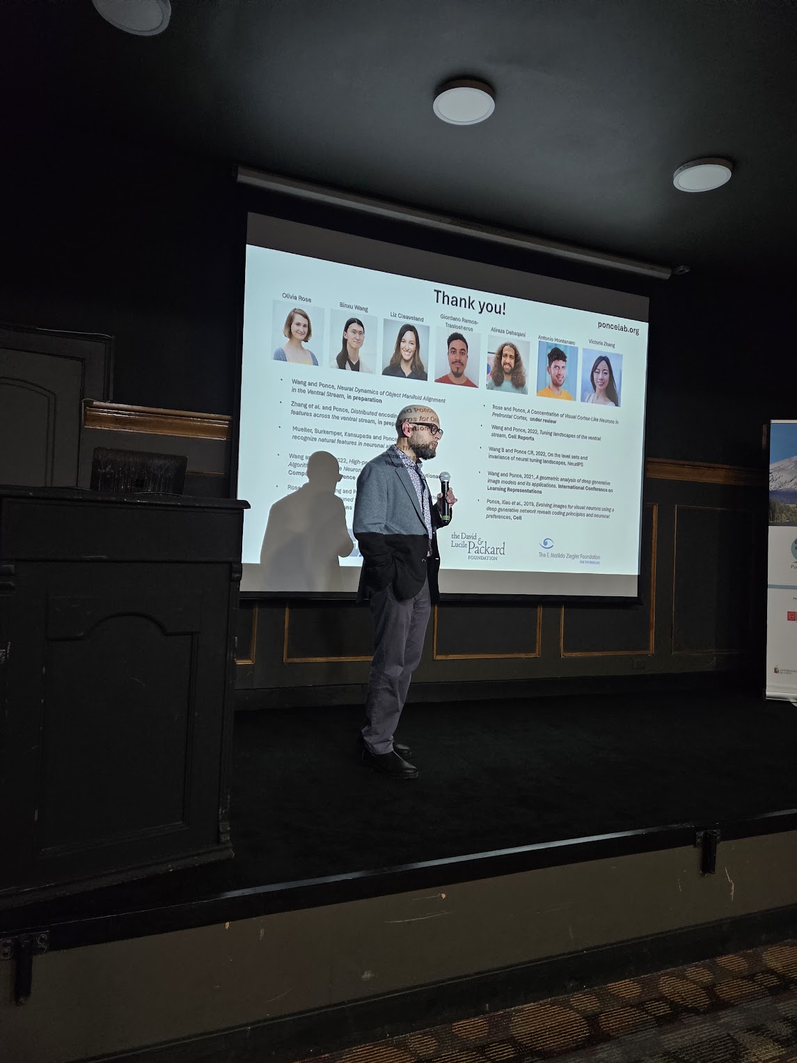 Carlos presenting his lab team at the end of a talk
